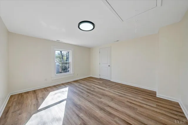 a white toilet sitting next to a bathroom sink and a mirror