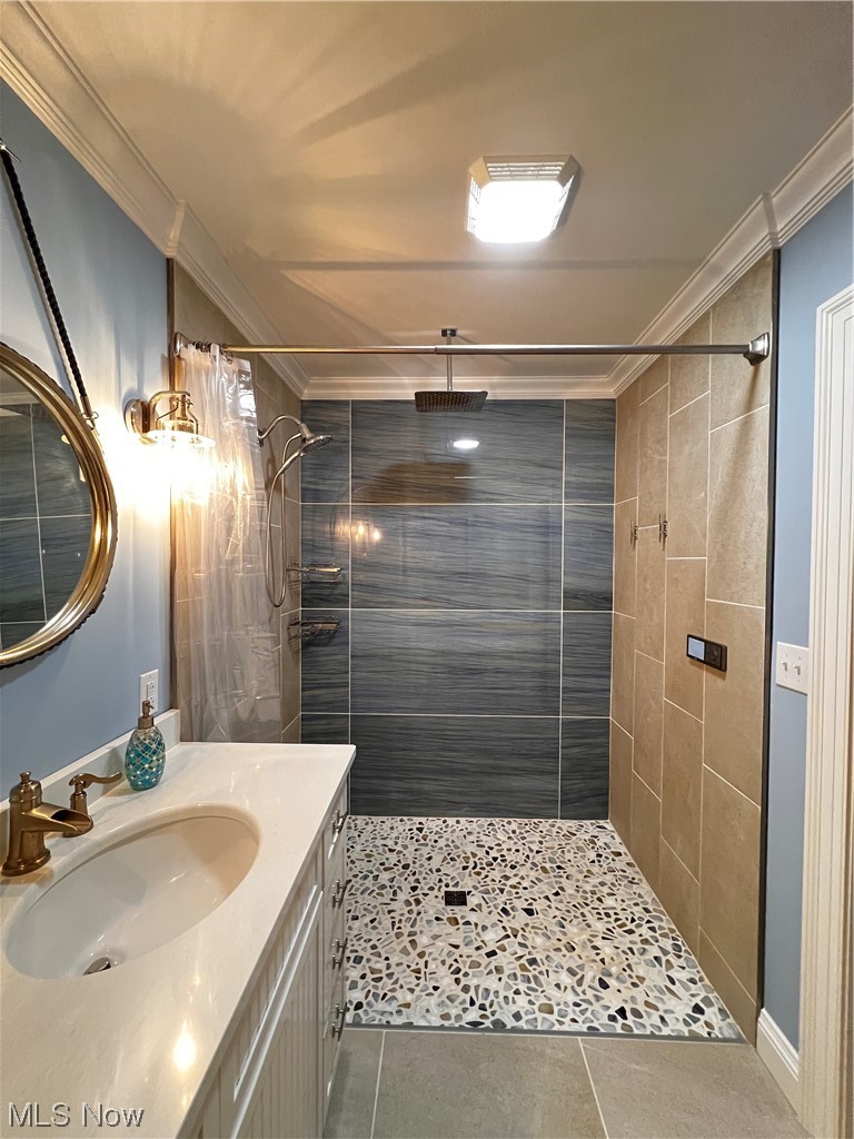 6213 Lake Road West Ashtabula, OH 44004 - Photo 22 of 30 Bathroom featuring vanity, a tile shower, ornamental molding, and tile flooring