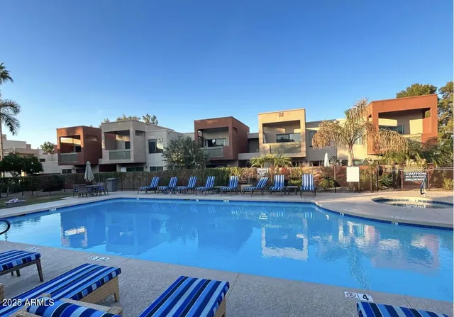 a view of a swimming pool with outdoor seating