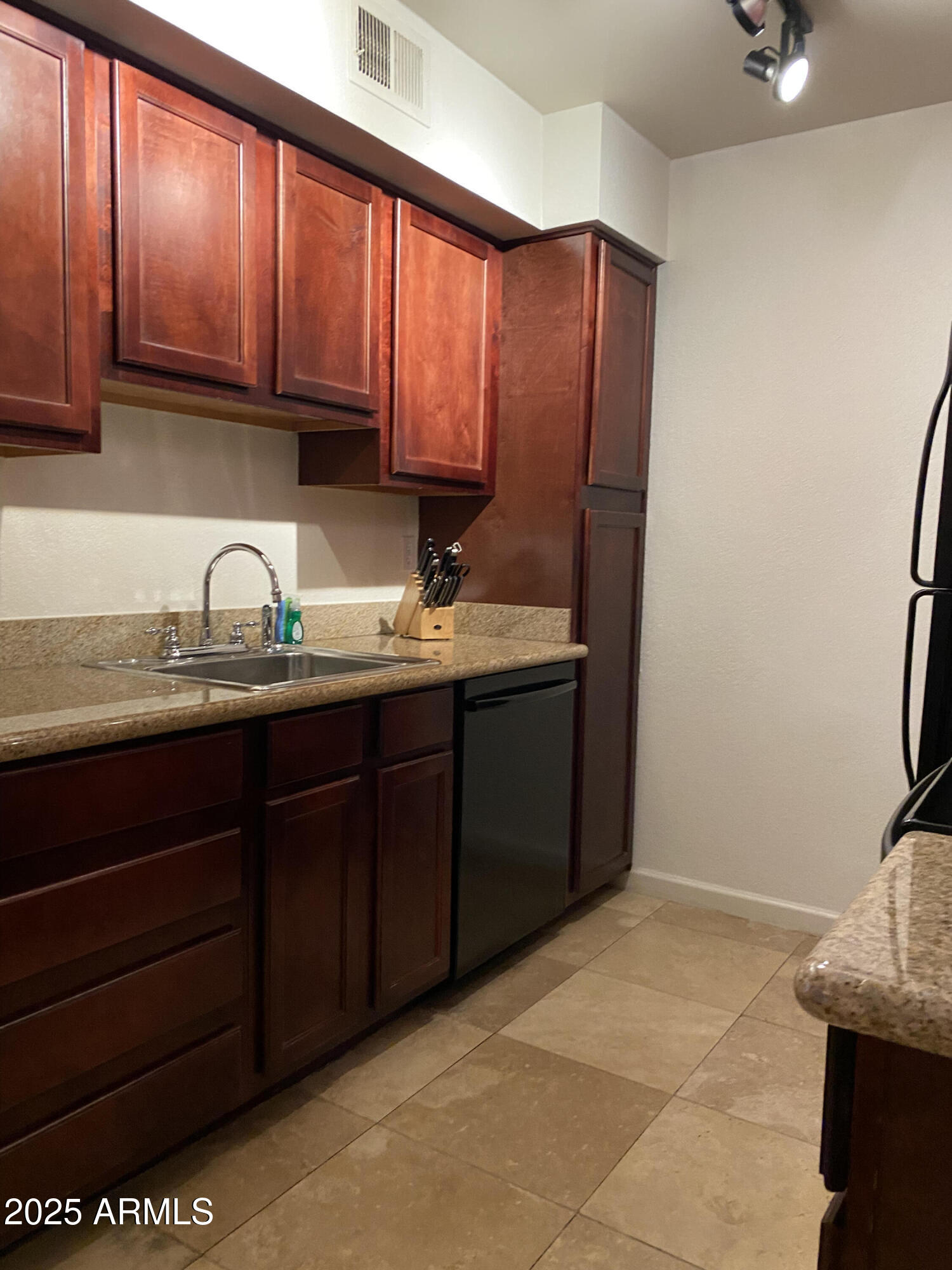 3500 North Hayden Road, Unit 105 Scottsdale, AZ 85251 - Photo 2 of 12 a kitchen with stainless steel appliances granite countertop a sink stove and cabinets