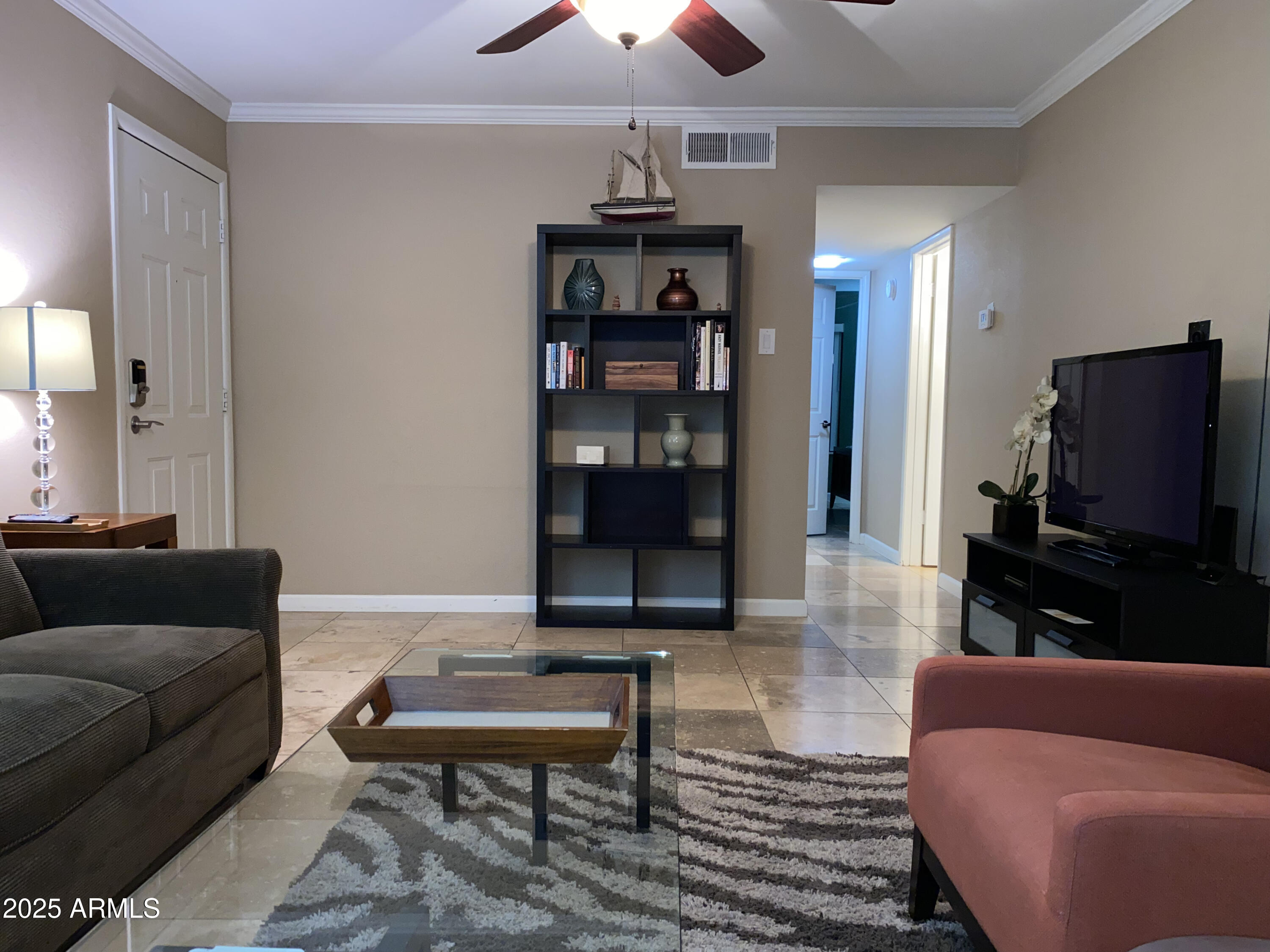 3500 North Hayden Road, Unit 105 Scottsdale, AZ 85251 - Photo 5 of 12 a living room with furniture and a flat screen tv