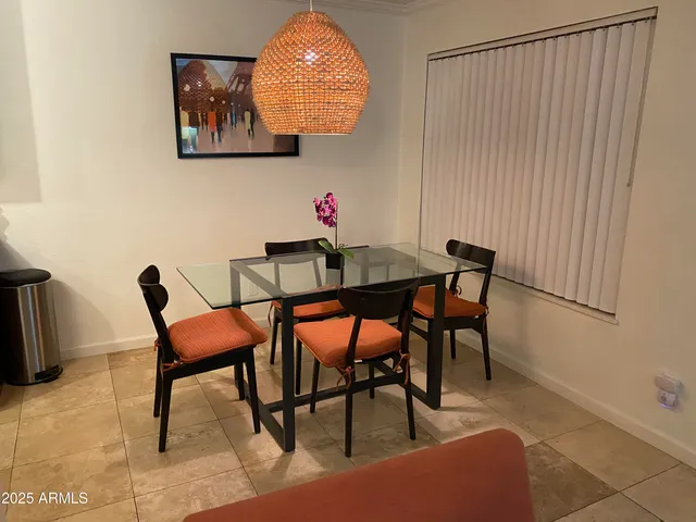 a view of a dining room with furniture and a potted plant