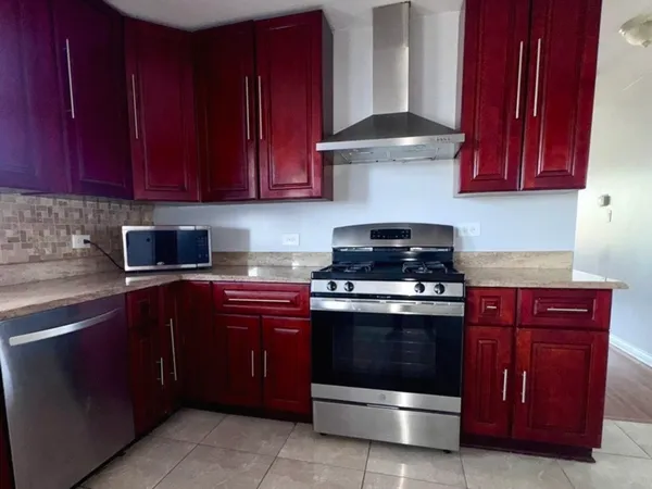 a kitchen with stainless steel appliances granite countertop a stove and a sink