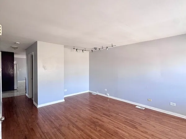 a view of a room with wooden floor
