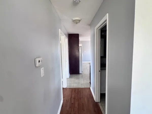 a view of a hallway with wooden floor