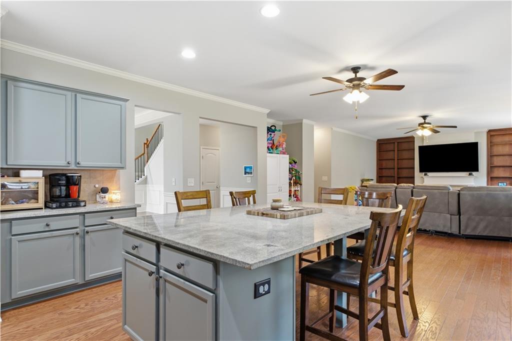 5825 Willow Oak Pass Cumming, GA 30040 - Photo 18 of 55 a kitchen with a table chairs refrigerator and microwave
