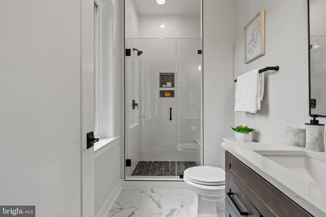 an empty room with windows and ceiling fan