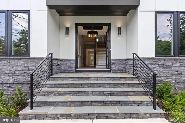 a view of a dining room with furniture and a chandelier