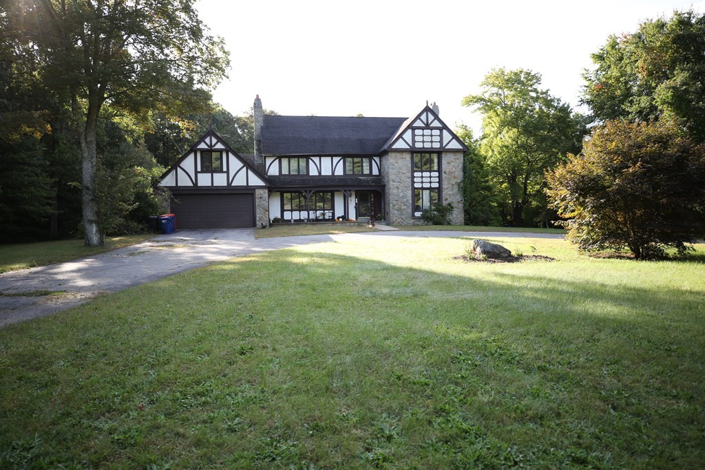 a front view of a house with a yard and garage
