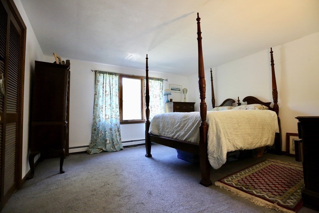 14 Gerrish Road Rochester, MA 02770 - Photo 22 of 40 a bedroom with a bed window and a mirror