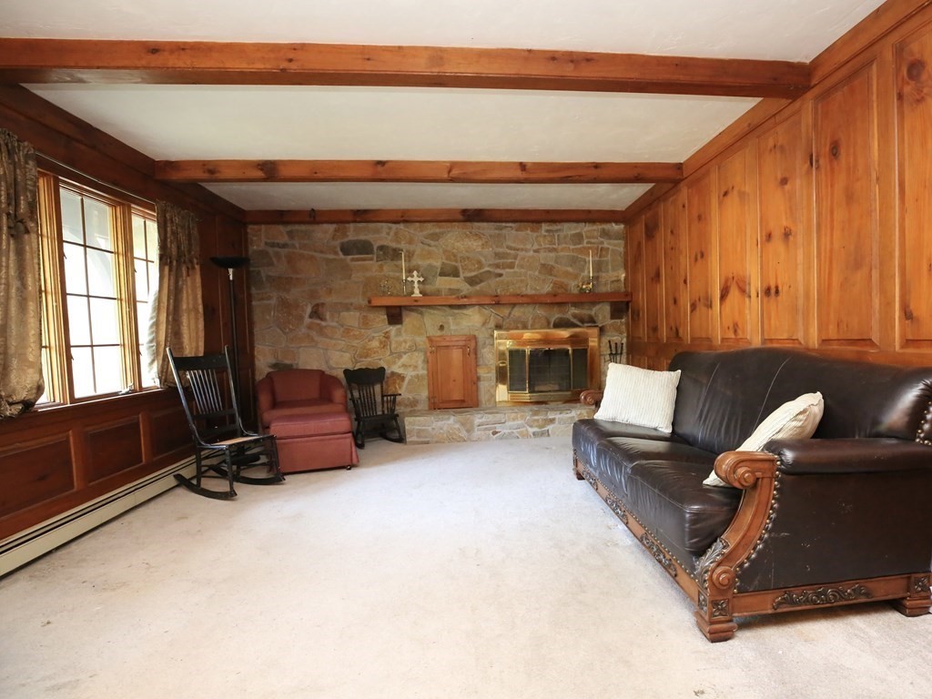 14 Gerrish Road Rochester, MA 02770 - Photo 7 of 40 a living room with furniture a flat screen tv and gym equipment