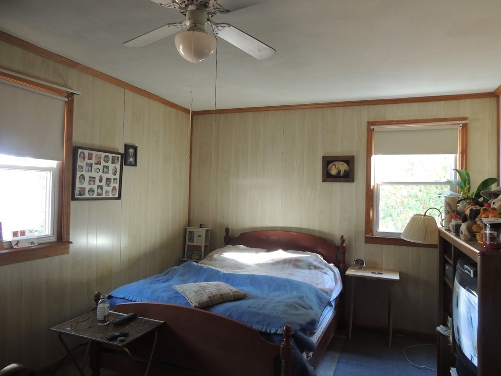 248 Fiberloid Street Springfield, MA 01151 - Photo 15 of 23 a bedroom with a bed and a chandelier