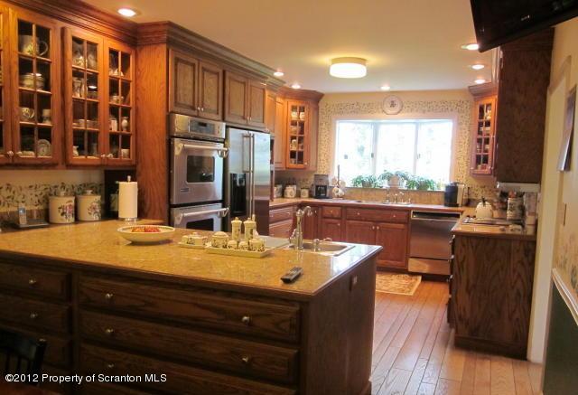 1121 Motichka Road Moscow, PA 18444 - Photo 12 of 59 a dining hall with stainless steel appliances granite countertop a stove and a sink