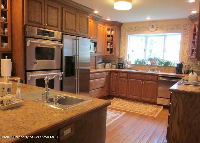 1121 Motichka Road Moscow, PA 18444 - Photo 13 of 59 a kitchen with stainless steel appliances granite countertop a sink stove and refrigerator