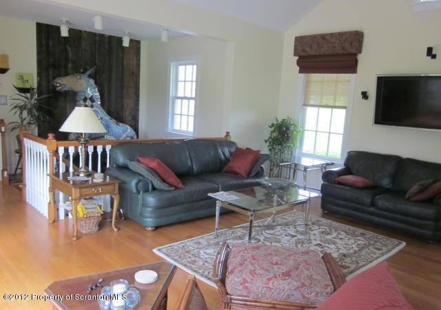 1121 Motichka Road Moscow, PA 18444 - Photo 16 of 59 a living room with furniture a flat screen tv and a window