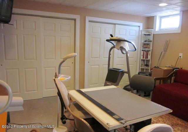 1121 Motichka Road Moscow, PA 18444 - Photo 18 of 59 a room with furniture and a window