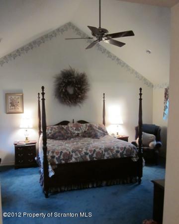 1121 Motichka Road Moscow, PA 18444 - Photo 29 of 59 a bedroom with a bed and a walk in closet