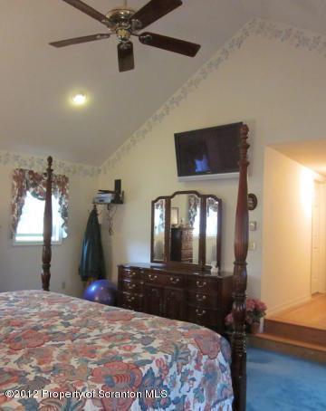 1121 Motichka Road Moscow, PA 18444 - Photo 32 of 59 a bedroom with a bed and a mirror on the dresser