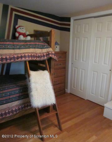 1121 Motichka Road Moscow, PA 18444 - Photo 40 of 59 a bed sitting in a room next to a window