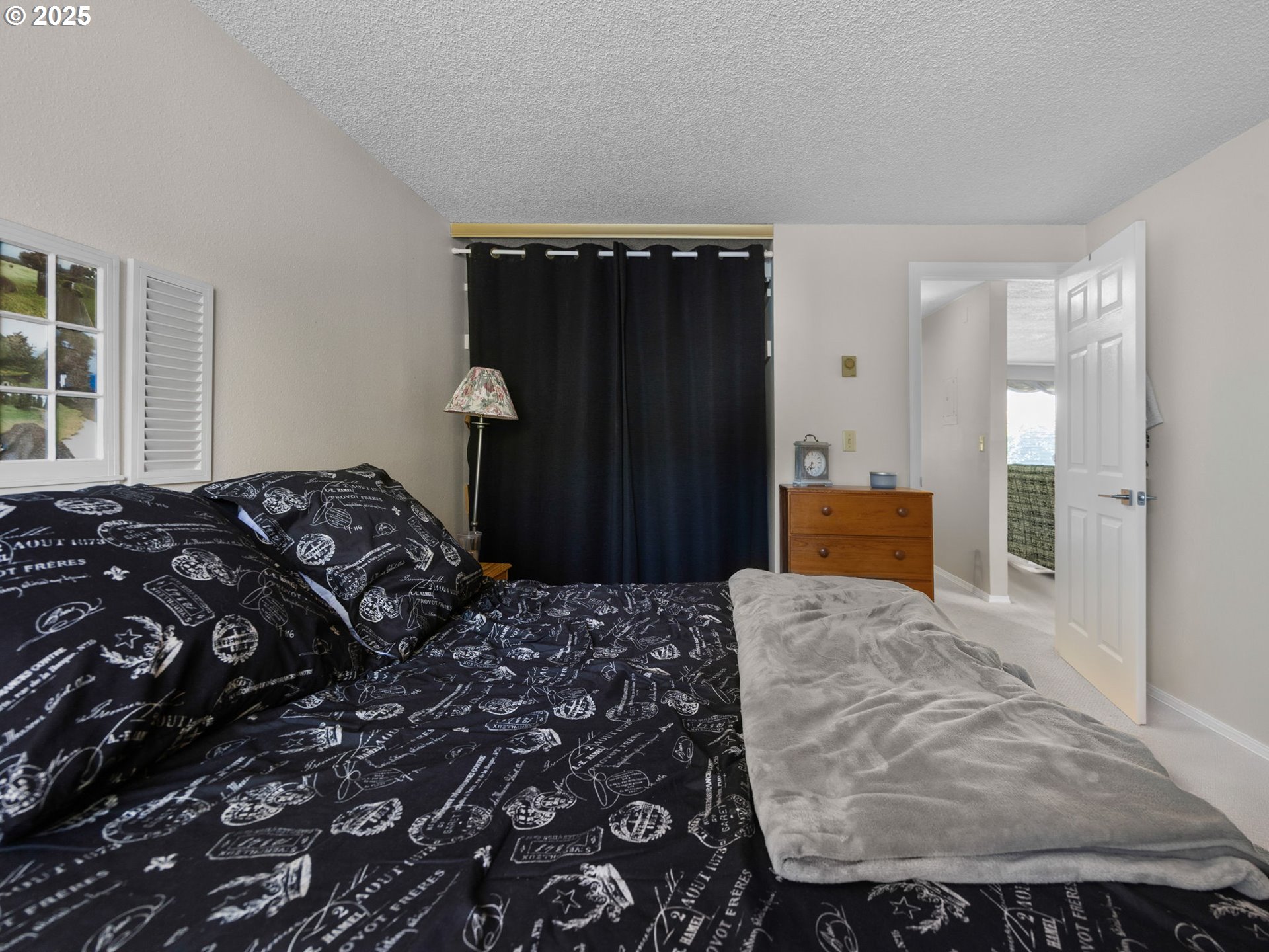 159 Southwest Florence Avenue, Unit 62 Gresham, OR 97080 - Photo 12 of 30 a bedroom with a bed and wooden floor