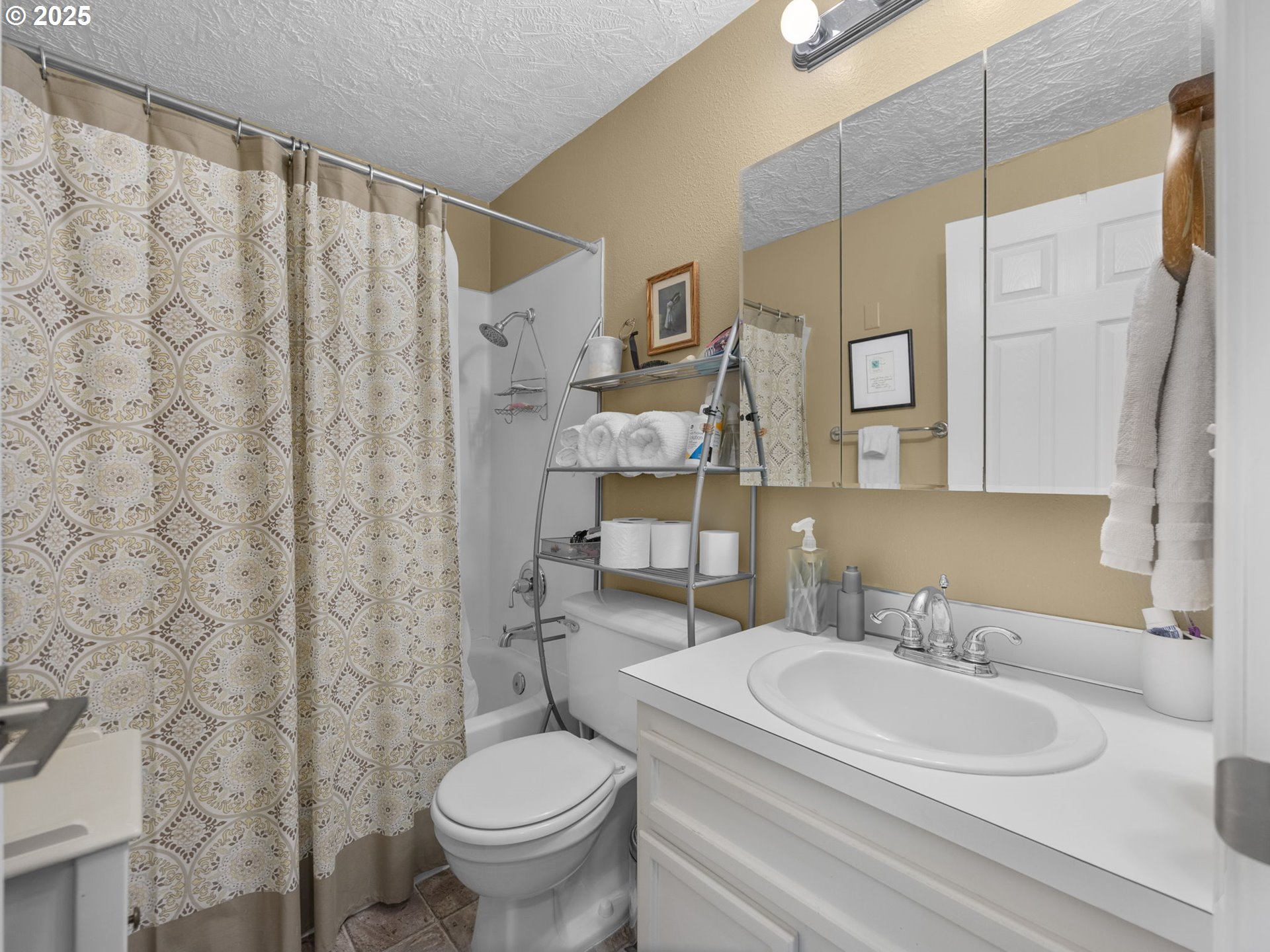 159 Southwest Florence Avenue, Unit 62 Gresham, OR 97080 - Photo 13 of 30 a bathroom with a sink a toilet and shower curtain