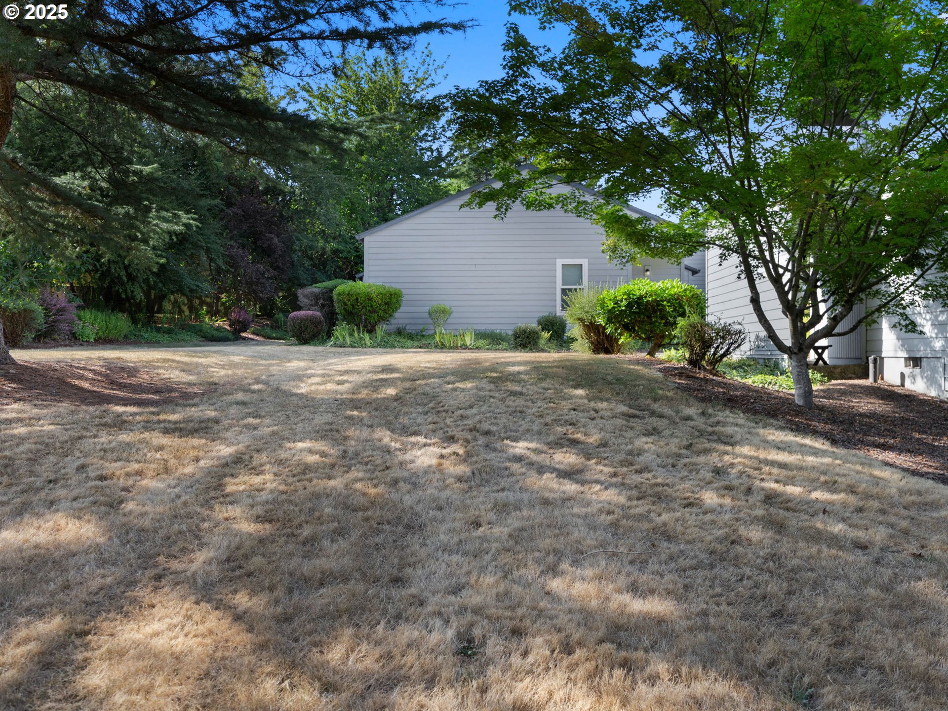 159 Southwest Florence Avenue, Unit 62 Gresham, OR 97080 - Photo 26 of 30 a backyard of a house with plants and trees