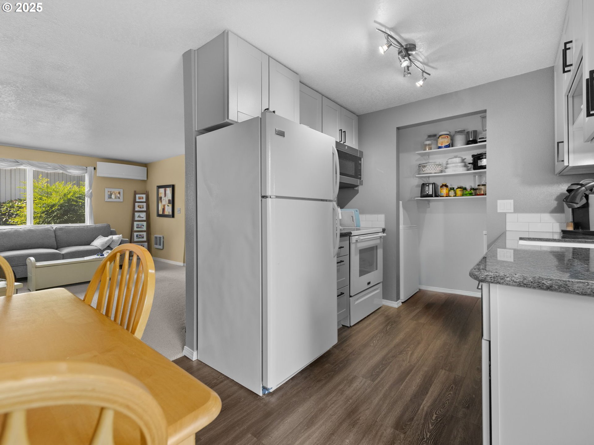 159 Southwest Florence Avenue, Unit 62 Gresham, OR 97080 - Photo 5 of 30 a kitchen with stainless steel appliances granite countertop a refrigerator a stove and a refrigerator