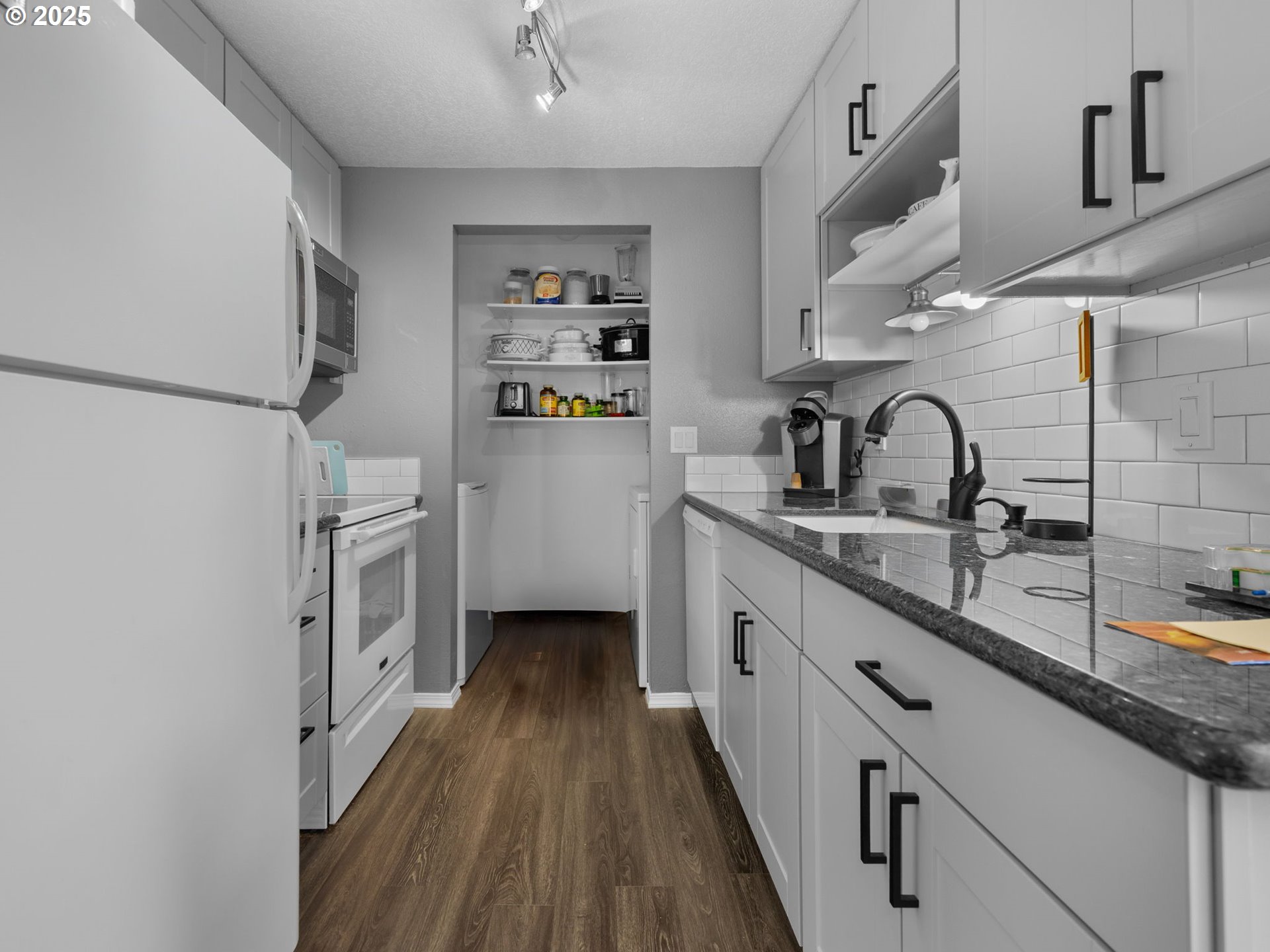 159 Southwest Florence Avenue, Unit 62 Gresham, OR 97080 - Photo 7 of 30 a kitchen with sink a refrigerator and cabinets