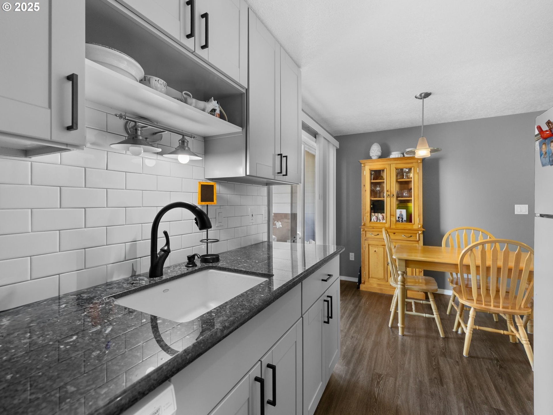 159 Southwest Florence Avenue, Unit 62 Gresham, OR 97080 - Photo 9 of 30 a kitchen with granite countertop sink a table and chairs