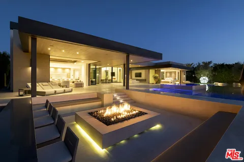 a living room with pool table and chairs