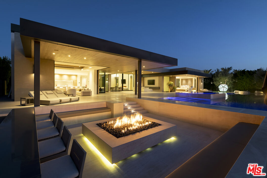 a living room with pool table and chairs