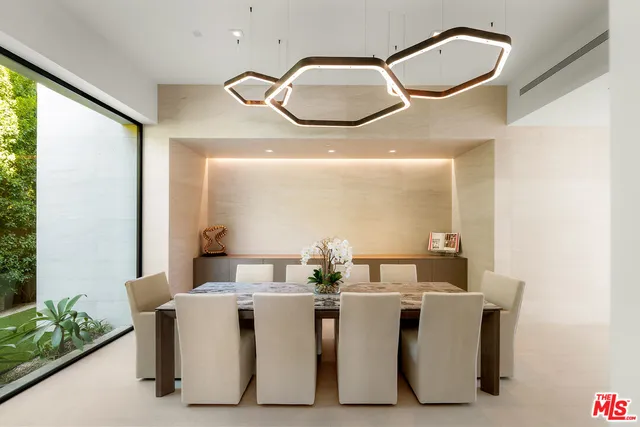 a dining room with furniture and a large window