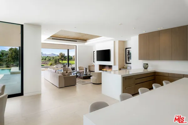a bedroom with furniture and large windows