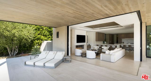 a spacious bedroom with a bed and large mirror