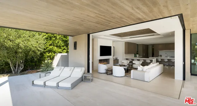 a spacious bedroom with a bed and large mirror