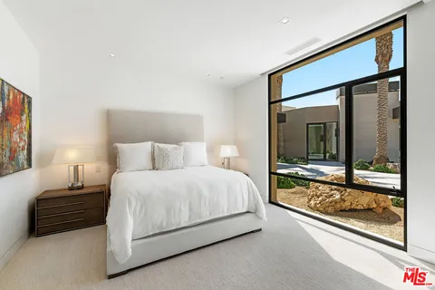 a view of a house with swimming pool and sitting area