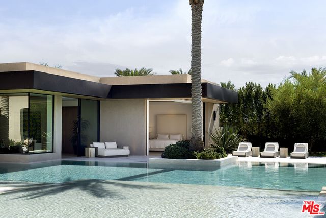 a front view of a house with a garden and plants