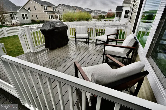 a balcony with table and chairs