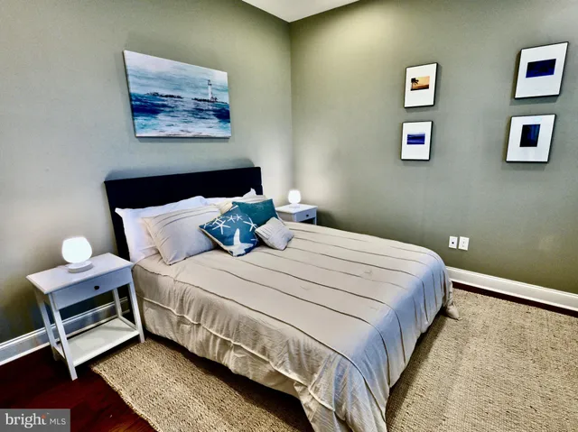 a bedroom with a bed and painting on the wall