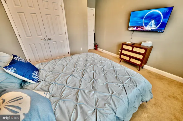 a bedroom with a bed and a painting on the wall
