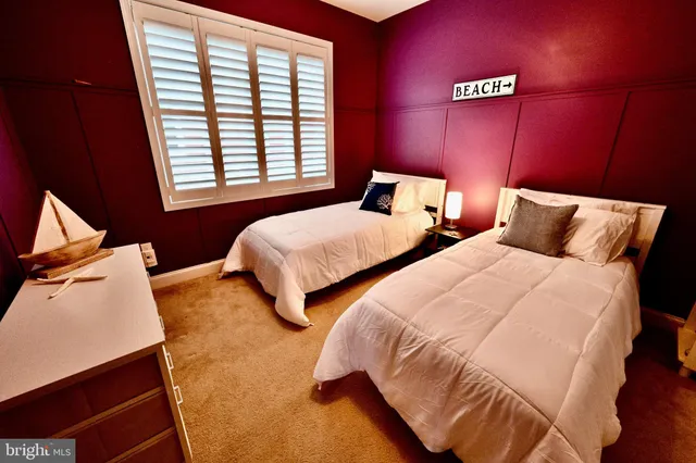 a bedroom with two beds and a window