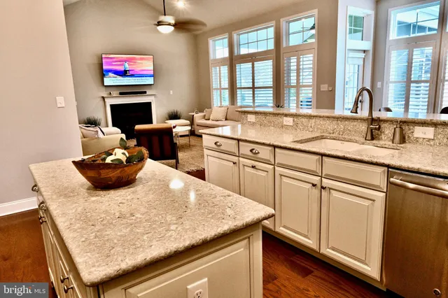 a kitchen with a sink a stove and a wooden floor