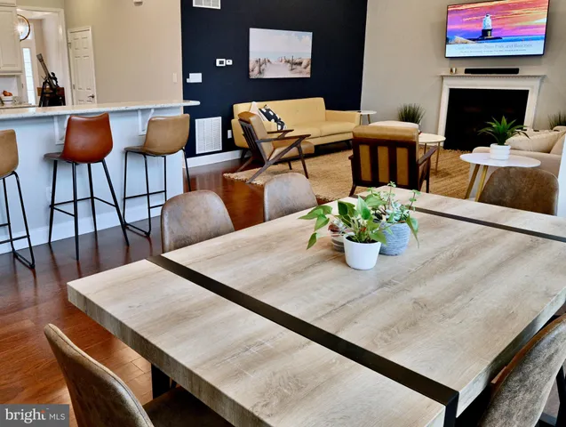a living room with furniture kitchen view and a fireplace