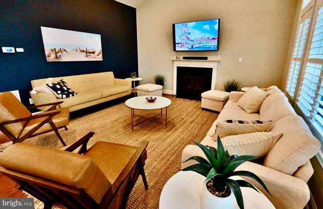 a living room with furniture kitchen and a fireplace