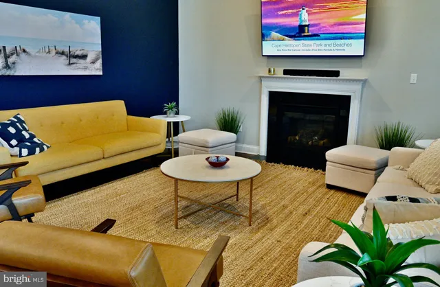 a living room with furniture a rug and a fireplace