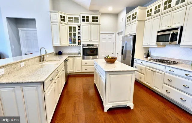 a kitchen with a sink a stove and a refrigerator