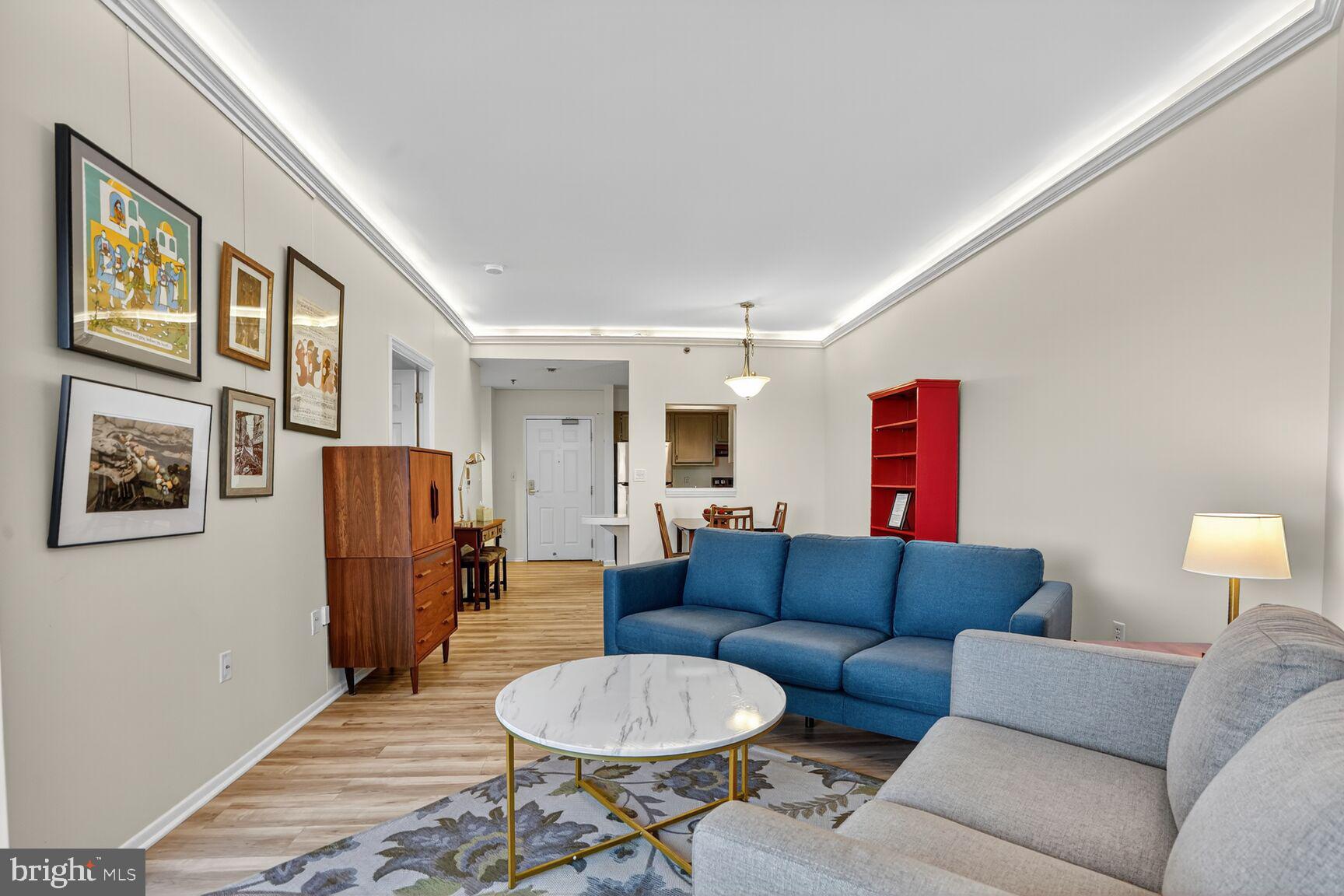 900 North Taylor Street, Unit 2110 Arlington, VA 22203 - Photo 12 of 42 a living room with furniture a refrigerator and a dining table