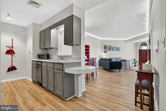 a kitchen with sink refrigerator and cabinets