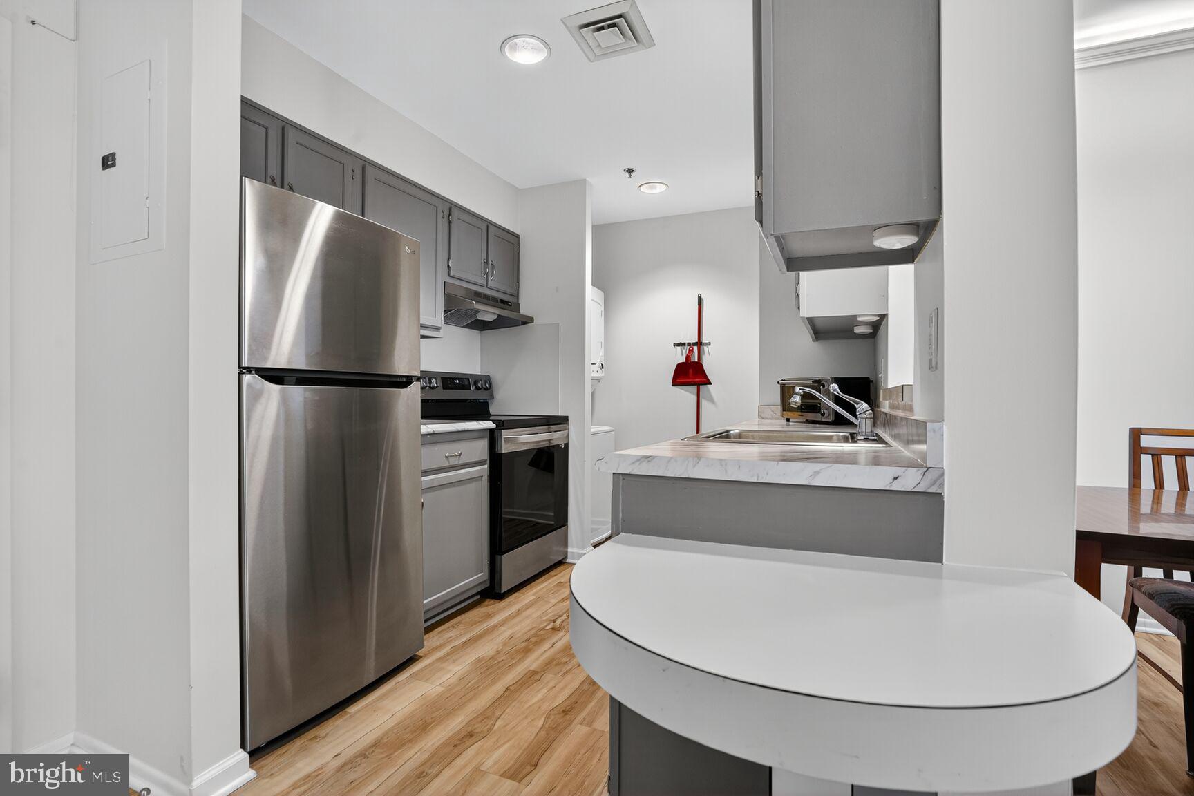 900 North Taylor Street, Unit 2110 Arlington, VA 22203 - Photo 3 of 42 a kitchen with stainless steel appliances a refrigerator stove and sink
