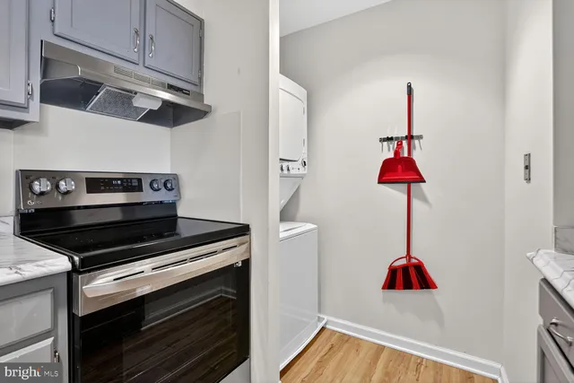 a kitchen with a stove cabinets and a wooden floor